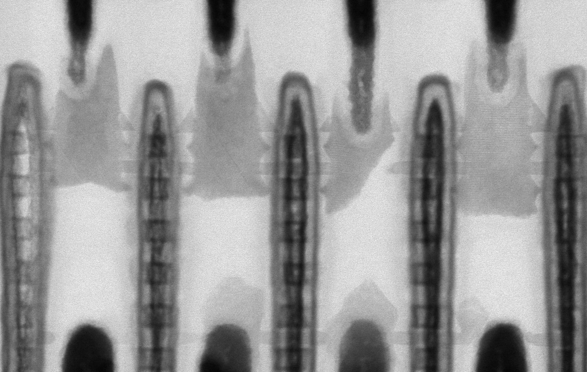 header_TEM%20double%20row%20CFET-cropped Transmission electron microscope image of a double-row CFET structure with repeating nanoscale transistor pillars.