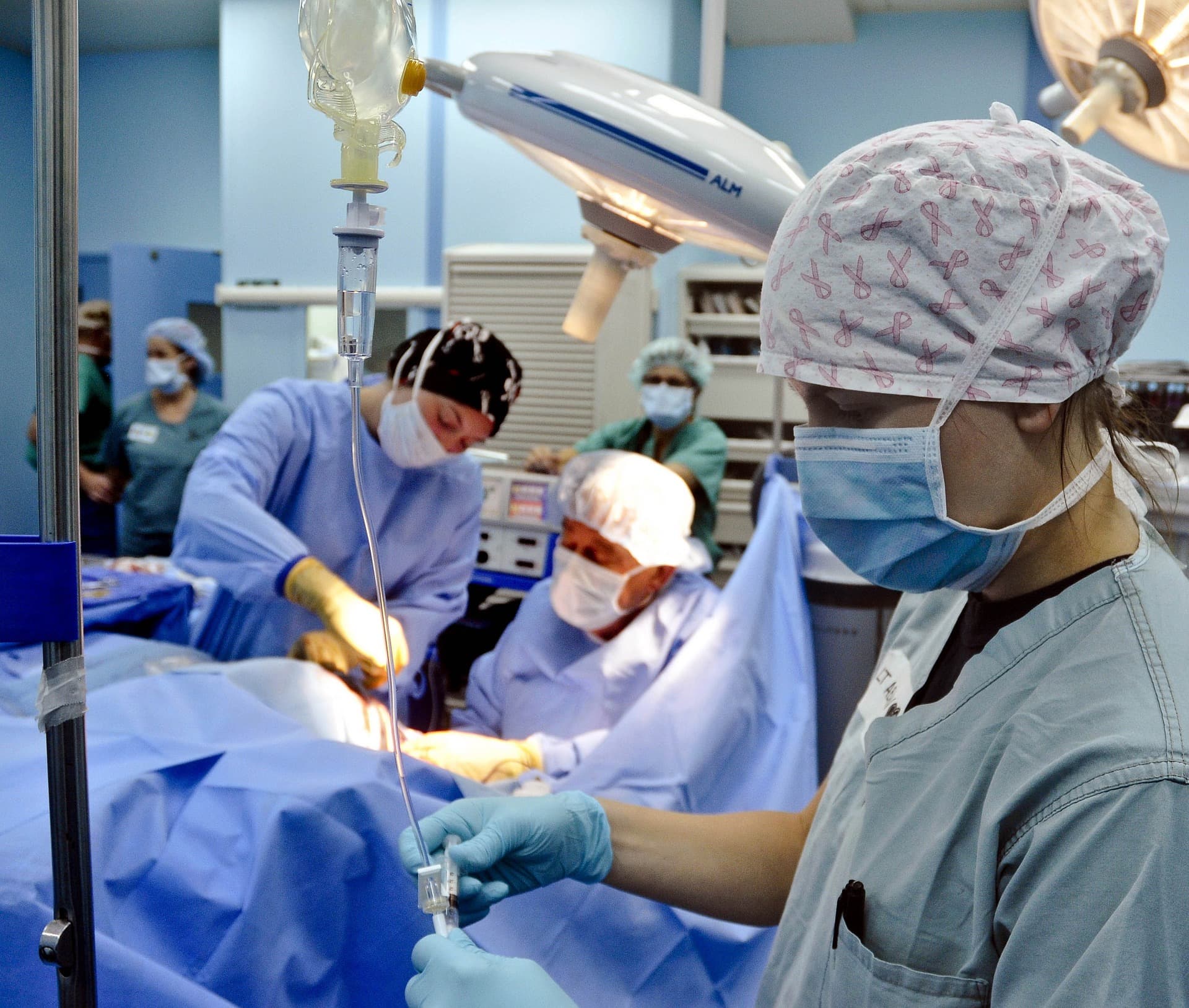 hyperspectral%20imaging%20microsurgery Masked surgical team in an operating room preparing for microsurgery