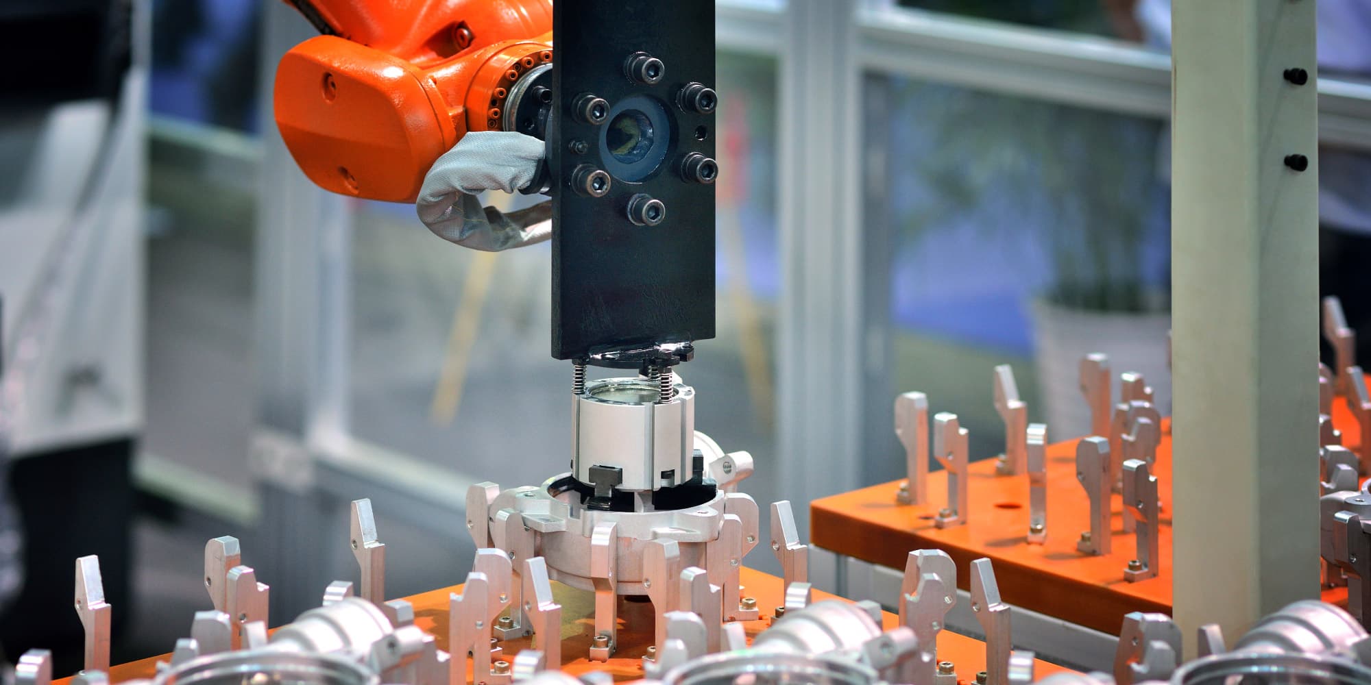 hyperspectral_HEADER Orange robotic arm positions a sensor over a production fixture in a lab setting