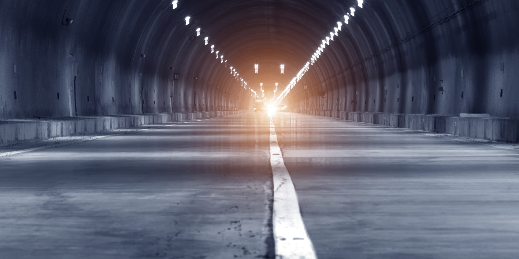 iAllow-magazine-imec Empty road tunnel with a bright light at the far end