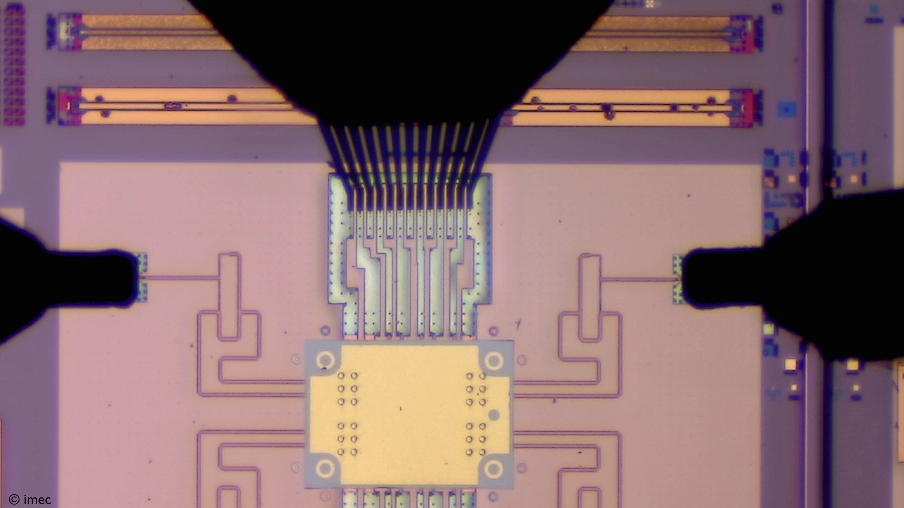 Microchip wafer layout with bonded chiplets under microscope Microchip wafer layout with bonded chiplets and fine interconnects under a microscope