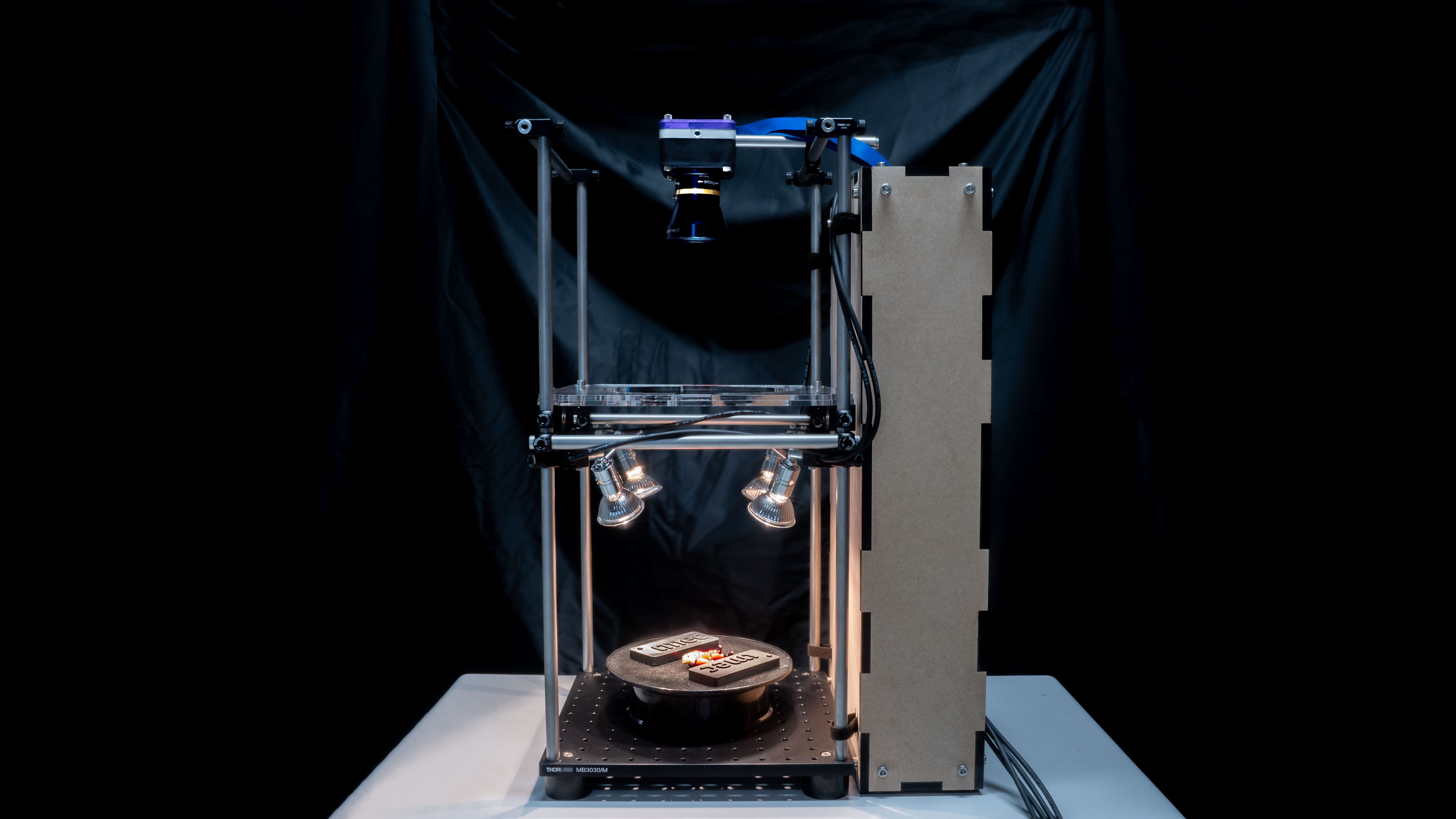 ImageSensor_0 Camera-integrated SWIR sensor demonstration setup with a mounted camera above illuminated sample holders