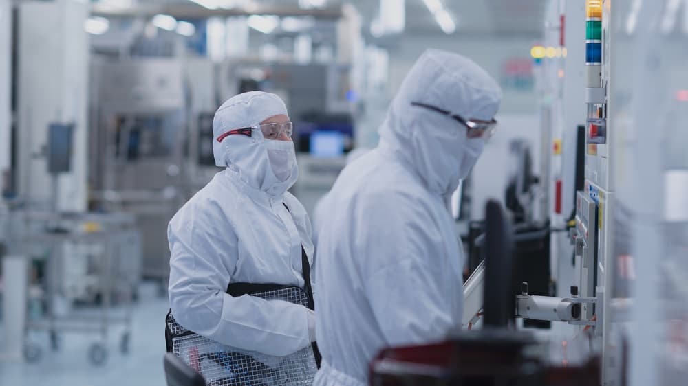 imec%20300mm%20cleanroom Researchers in white cleanroom suits working at semiconductor equipment in a cleanroom