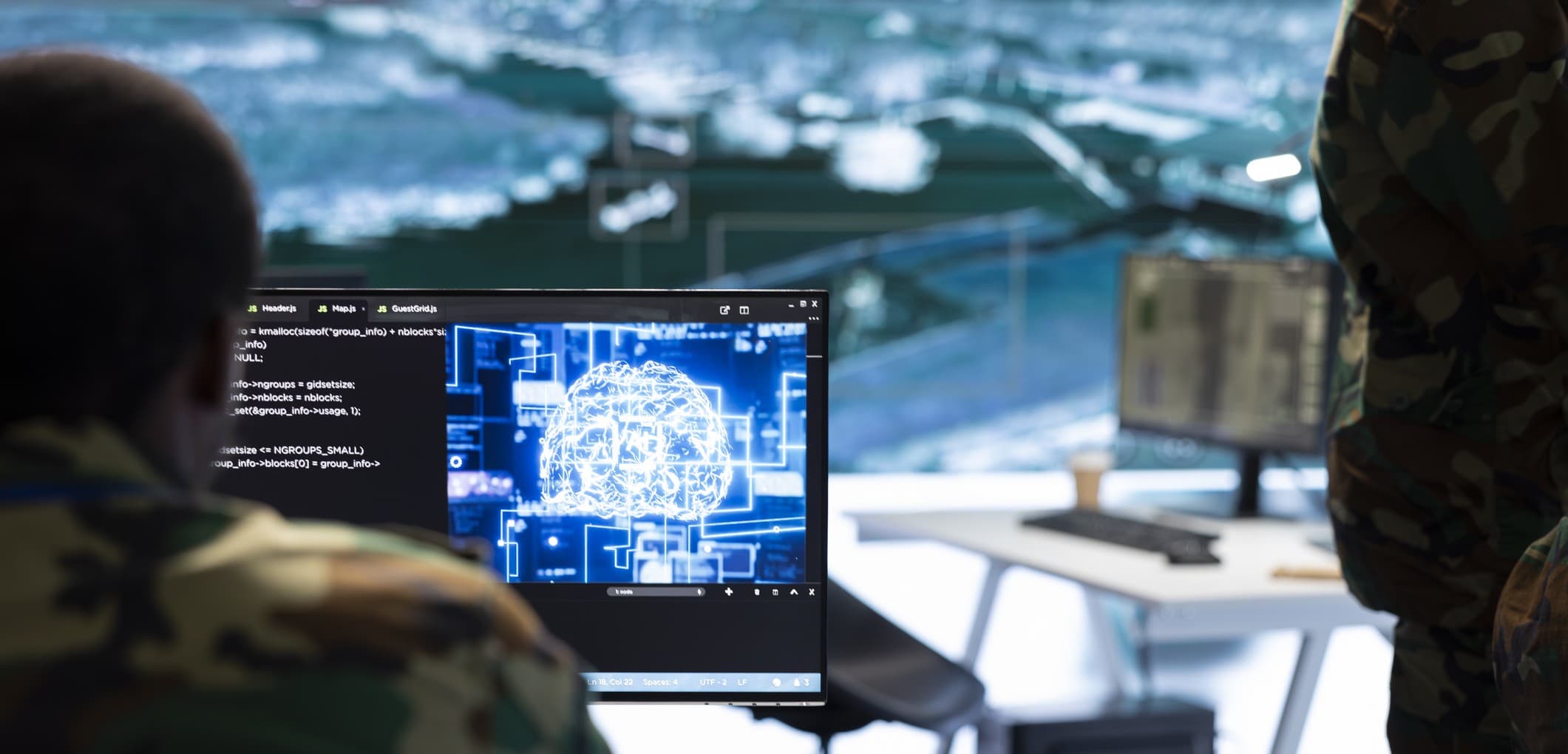Imec%20security%20technologies Military personnel viewing a computer screen with a glowing digital brain interface in a command center
