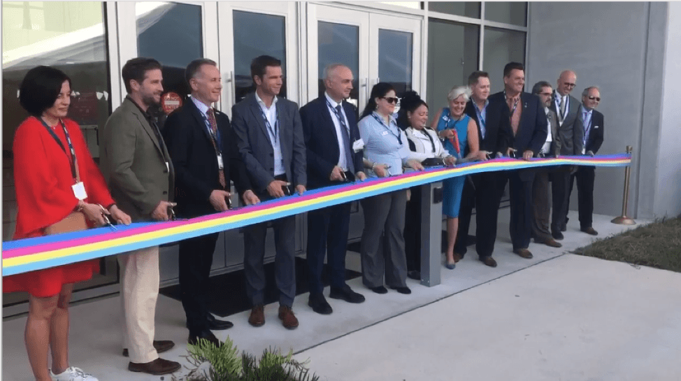 imec_florida_opening_0 Group of officials and guests holding a ribbon at the opening of imec Florida's new office in NeoCity.
