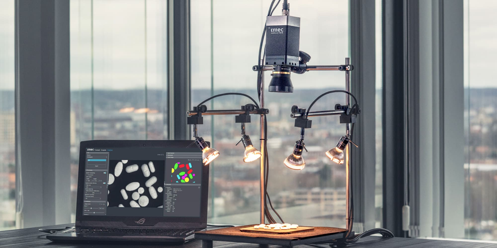 imec-introduces-three-new-hyperspectral-imaging-systems-outside-the-lab Hyperspectral imaging setup with a camera, lighting rig, and laptop analyzing sample pills