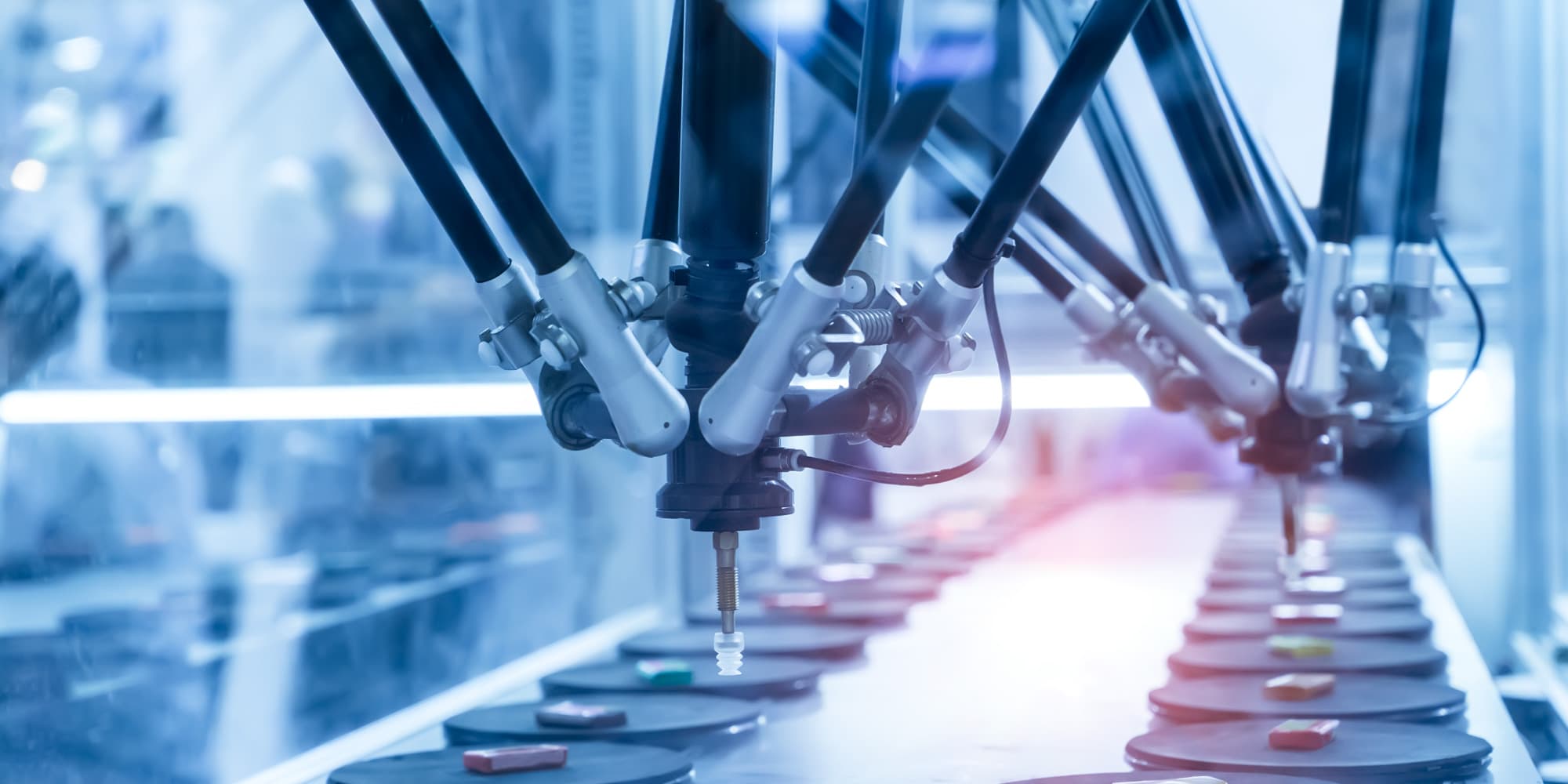 imec-magazine-ai-special-12_gevolgenai_1 Robotic arms in a cleanroom moving components along an automated production line