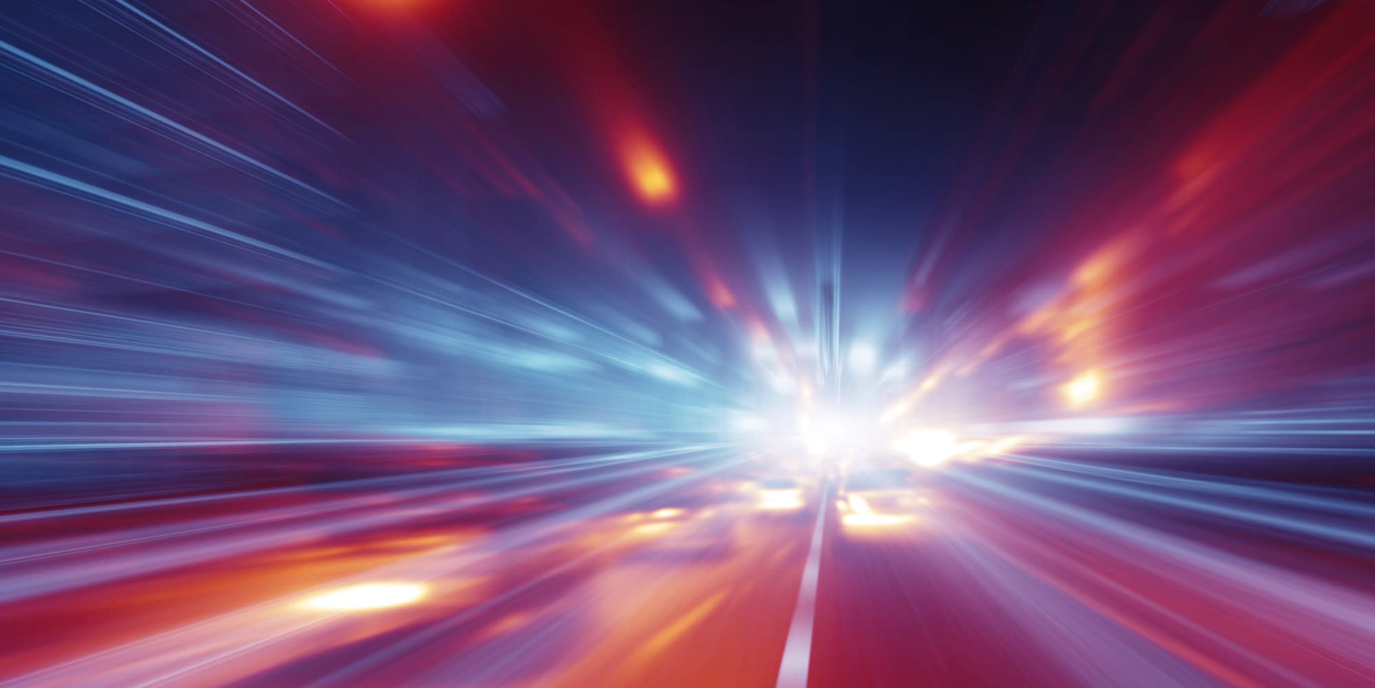 imec-magazine-centered3_1 Abstract streaks of blue and red light radiating from a bright center, suggesting rapid digital innovation