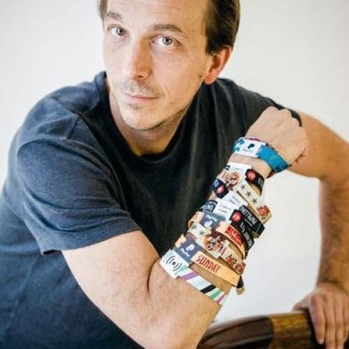 imec-magazine-david-de-wever-bio_1 Portrait of David De Wever wearing several colorful RFID wristbands on his arm