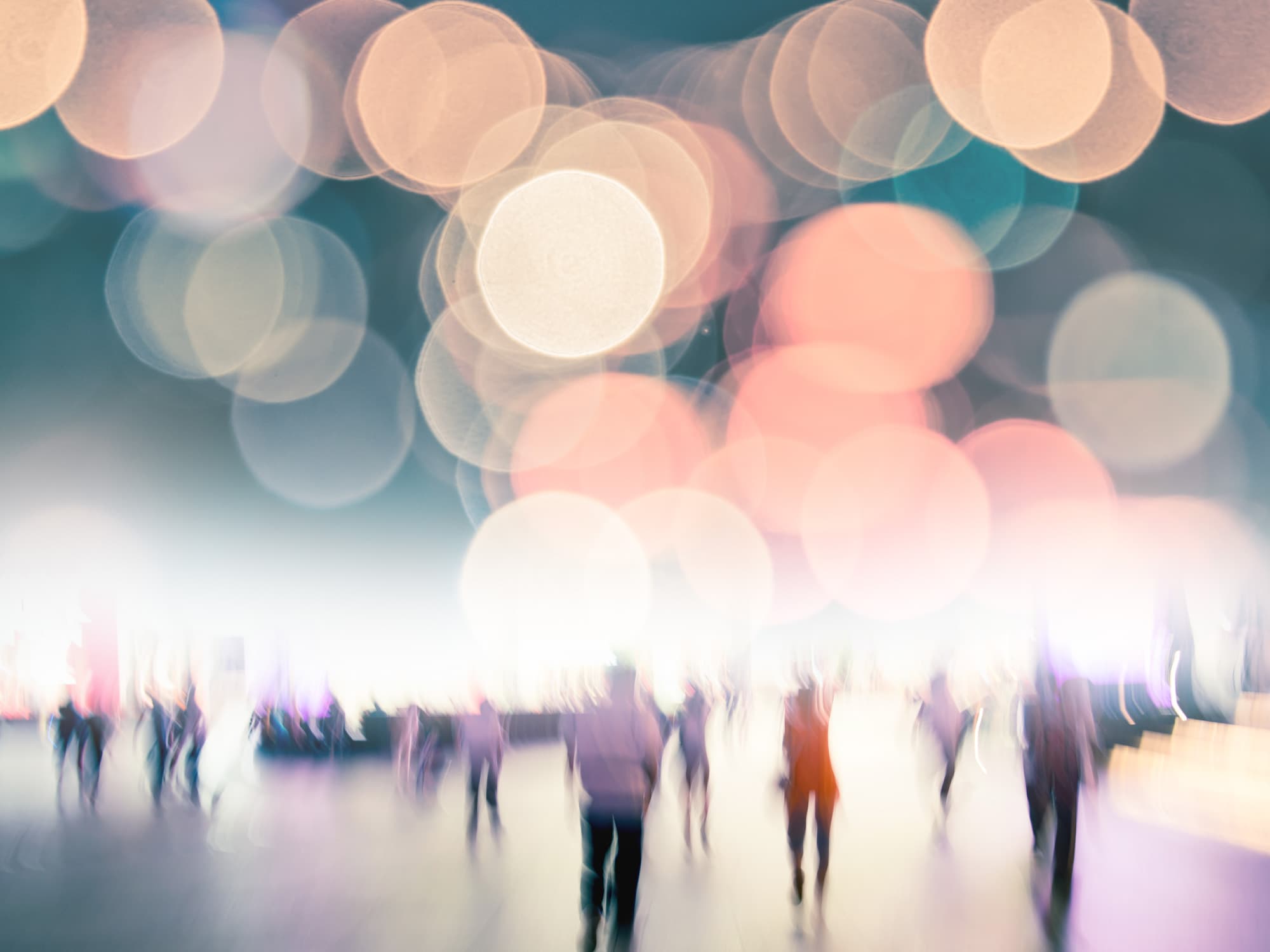 imec-magazine-smart-cities-header_1 Blurred crowd of people beneath colorful lights at an event venue