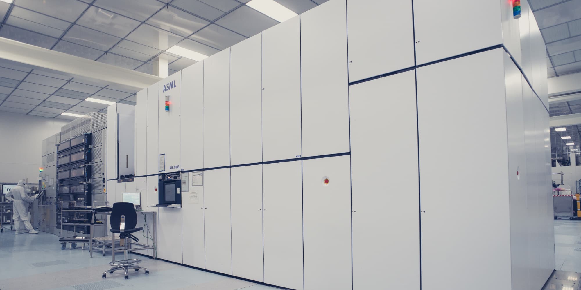 Imec-Pushes-Single-Exposure-Patterning-Capability ASML semiconductor lithography tool in a cleanroom with a researcher nearby
