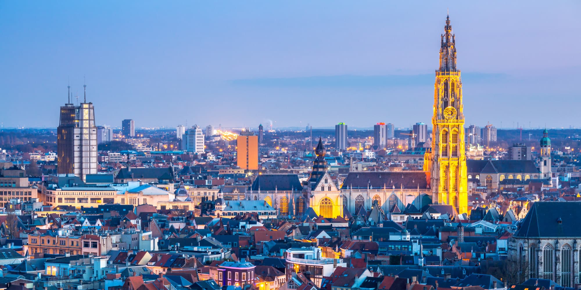 imec-smart-cities-antwerpen_1 Antwerp skyline at dusk with the illuminated Cathedral of Our Lady rising above the city