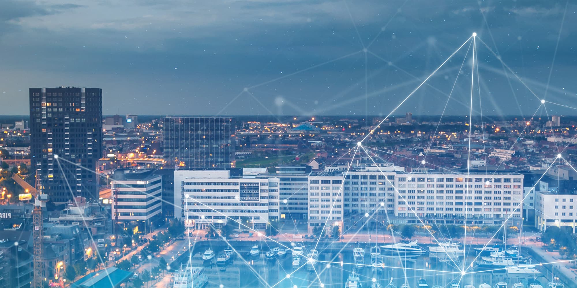imec-smart-city-meter_1 City skyline at dusk with a network graphic overlay connecting buildings and lights
