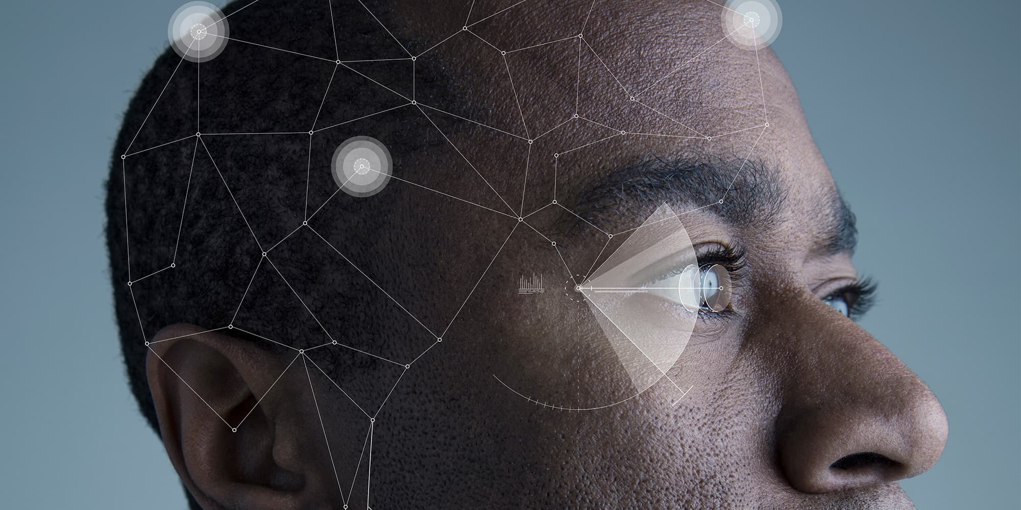 implantables_web_visual2_1 Profile of a man with a digital overlay highlighting the eye, suggesting an implantable medical device concept