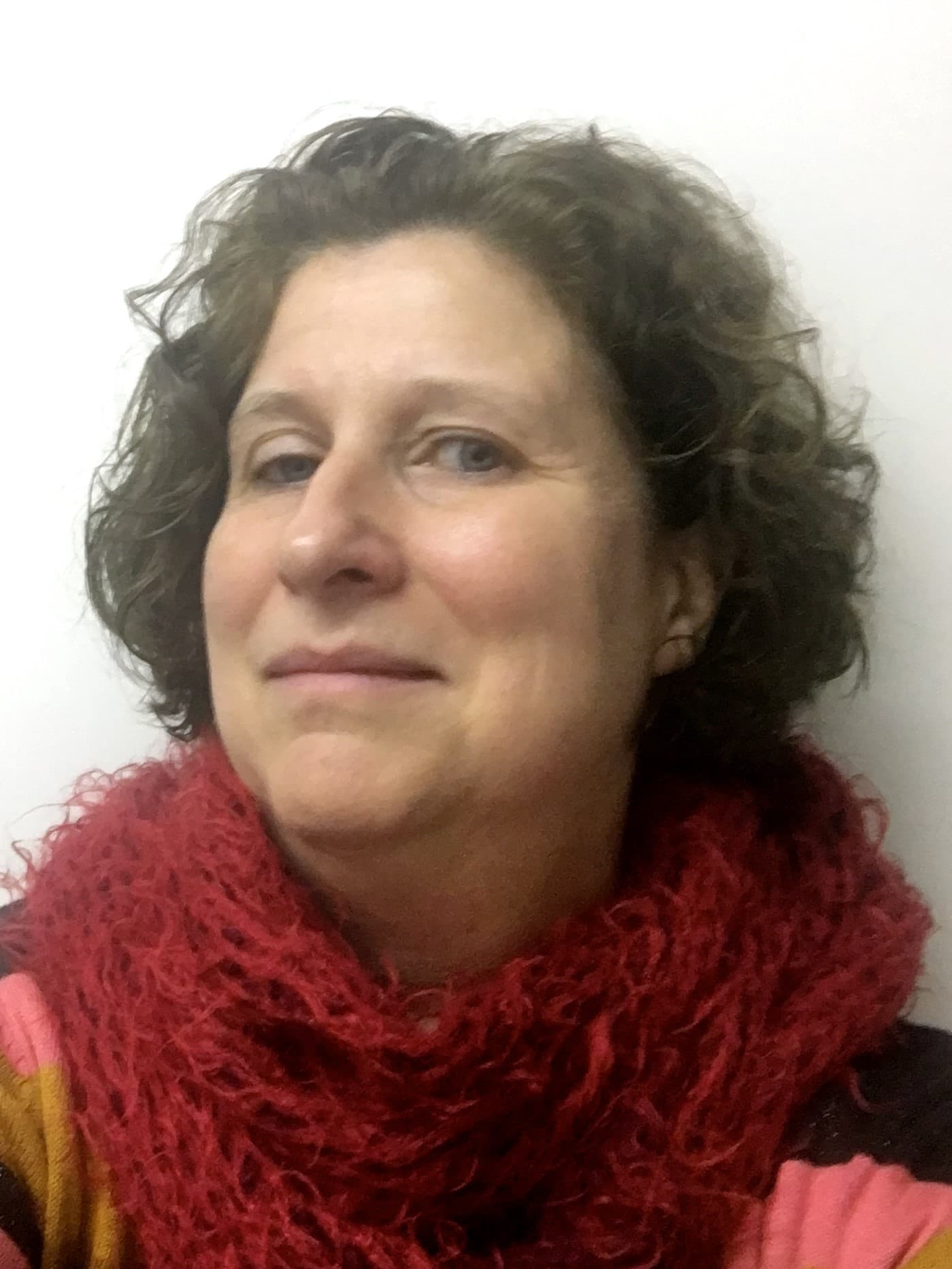 Ingrid_Moerman_1 Portrait of Ingrid Moerman wearing a red scarf against a plain white background.