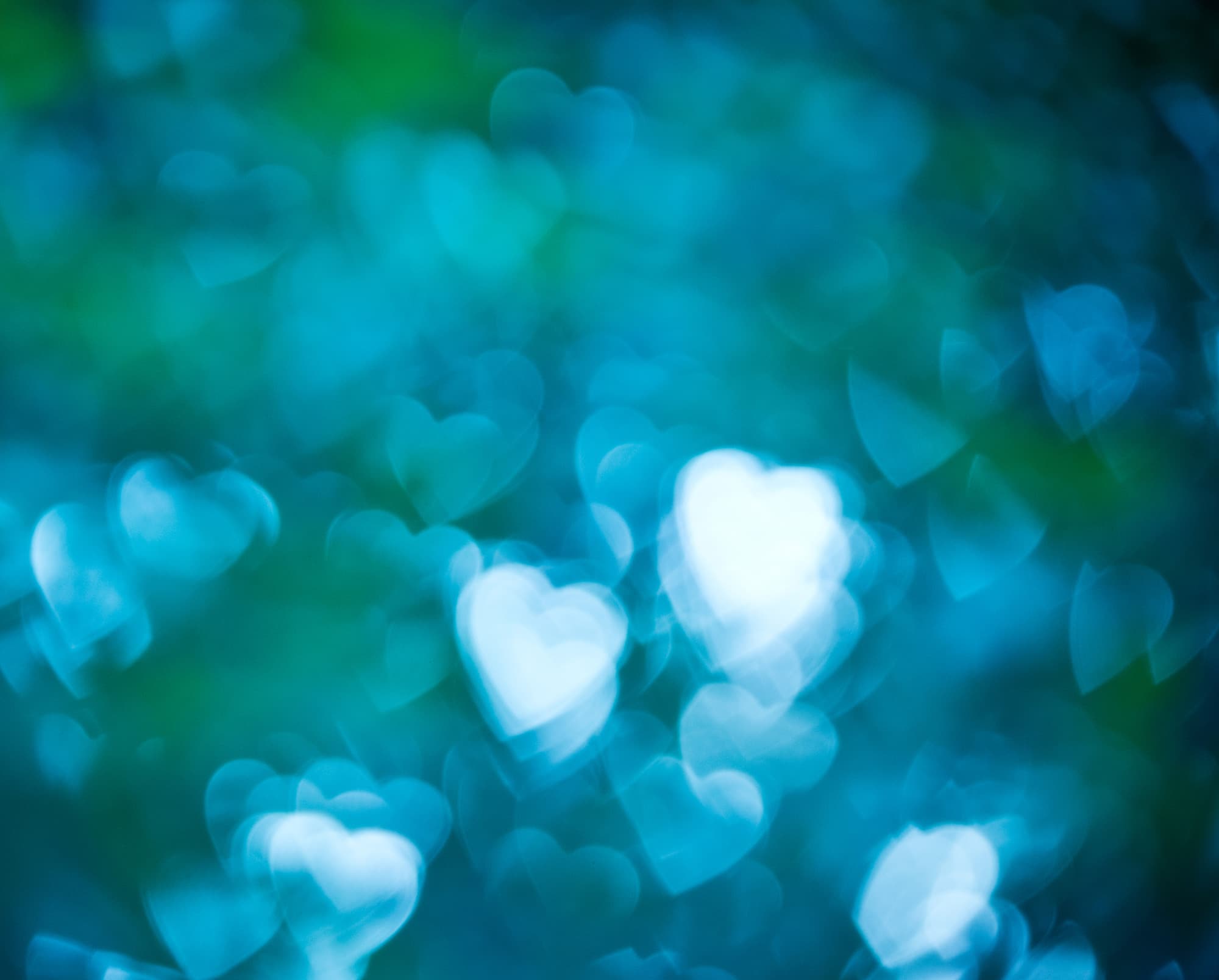 iStock-601140524_1 Abstract blue and green bokeh lights with heart-shaped highlights
