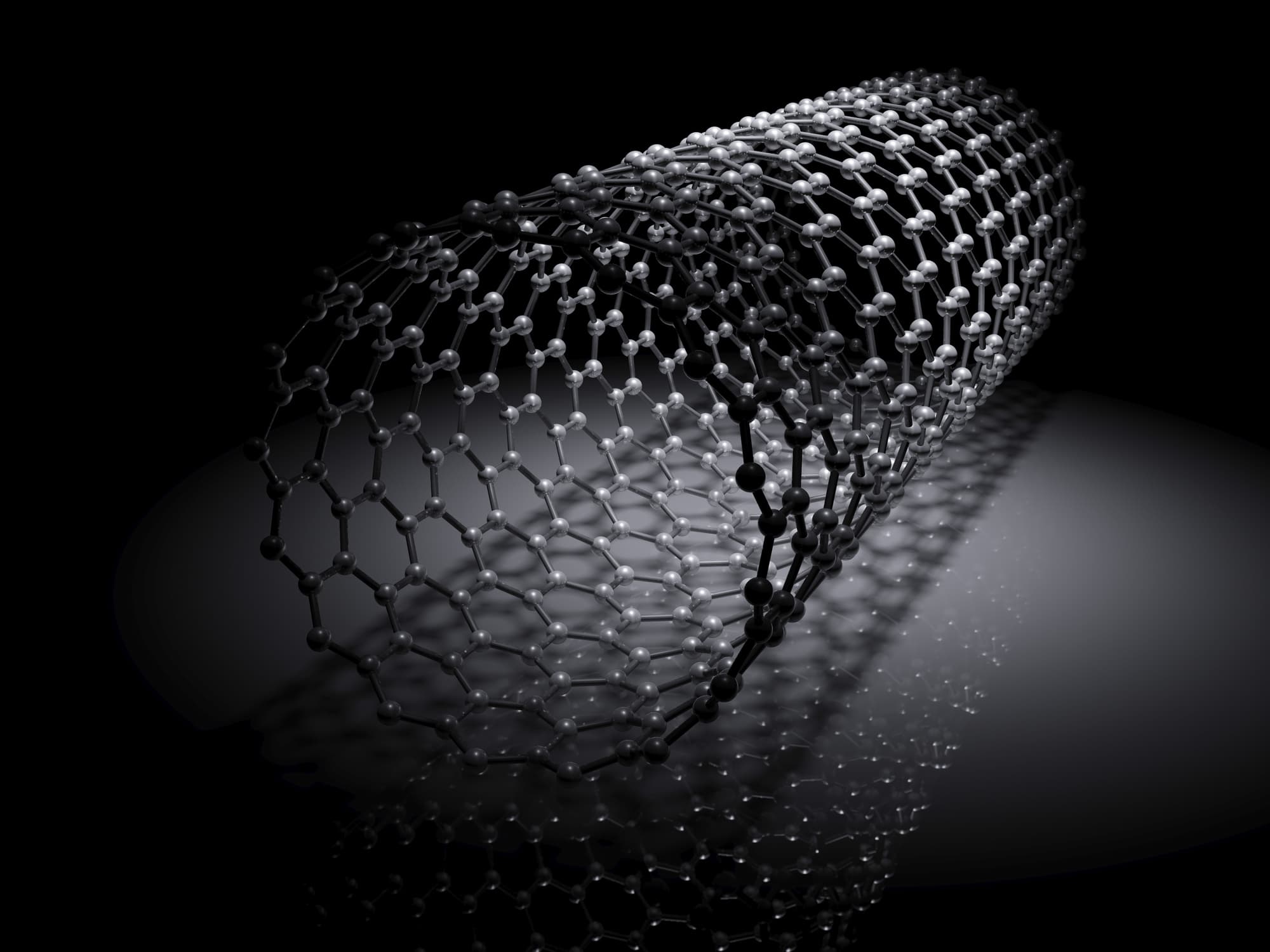 iStock-908521698_0 3D render of a rolled graphene-like hexagonal lattice on a dark background