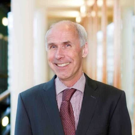 jaap Portrait of Jaap Lombaers in a suit and tie, smiling in a bright hallway