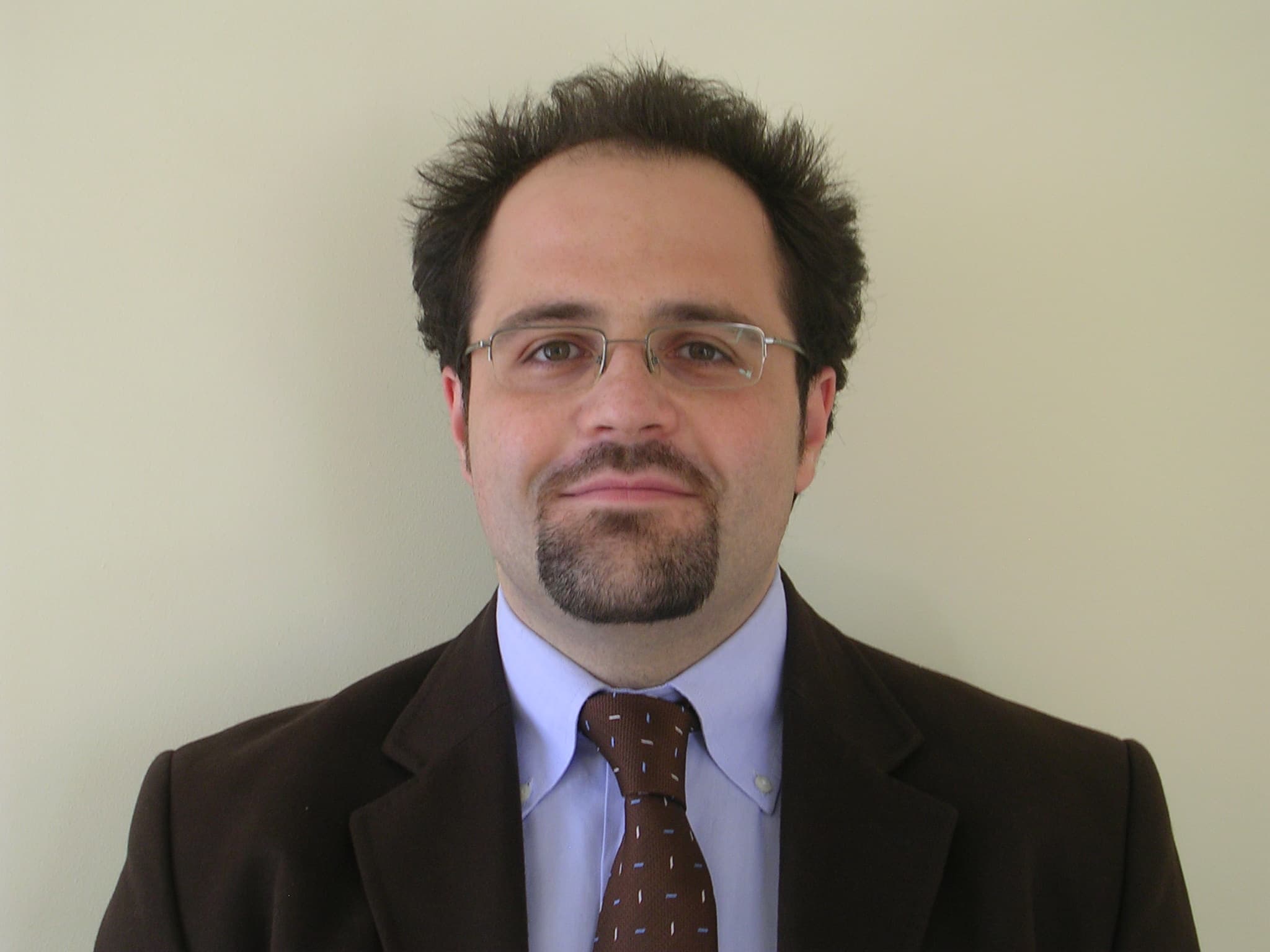 Jacopo%20Franco Portrait of Jacopo Franco wearing glasses, a suit, and a tie against a plain background