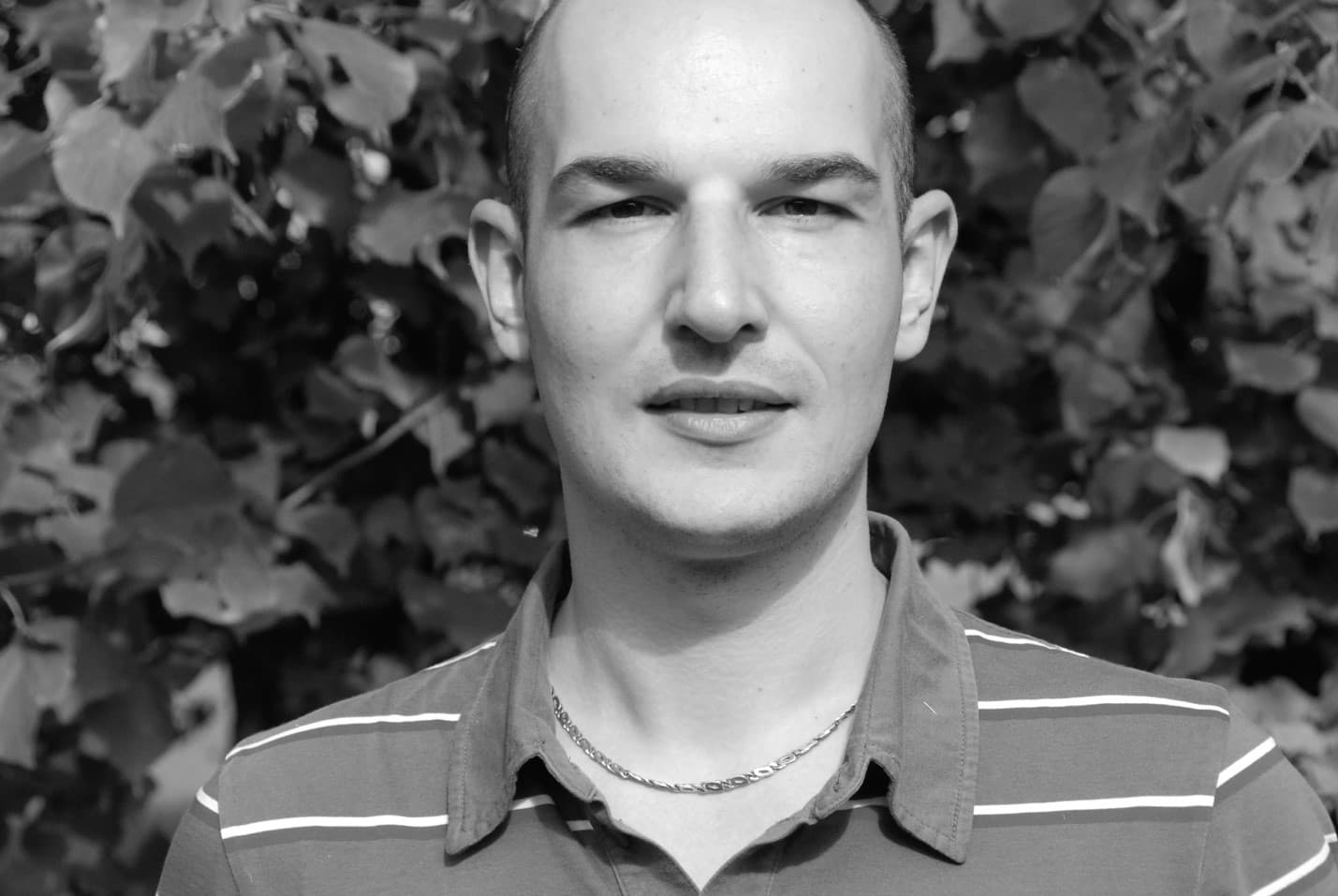 Jan_Coppens_1 Black-and-white headshot of Jan Coppens against a leafy background