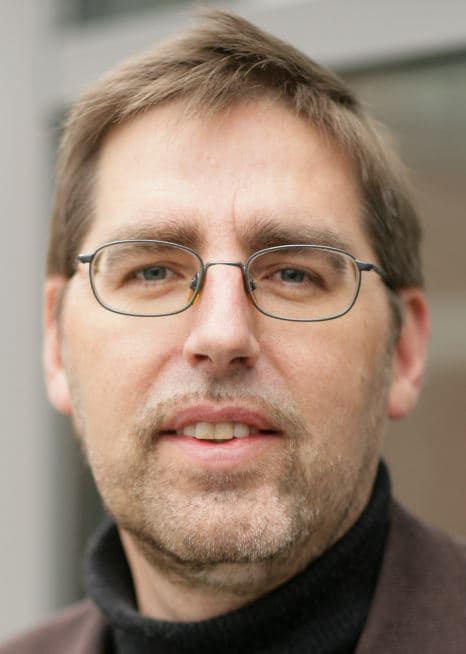 Jozef-Poortmans_1 Portrait of Jozef Poortmans wearing glasses