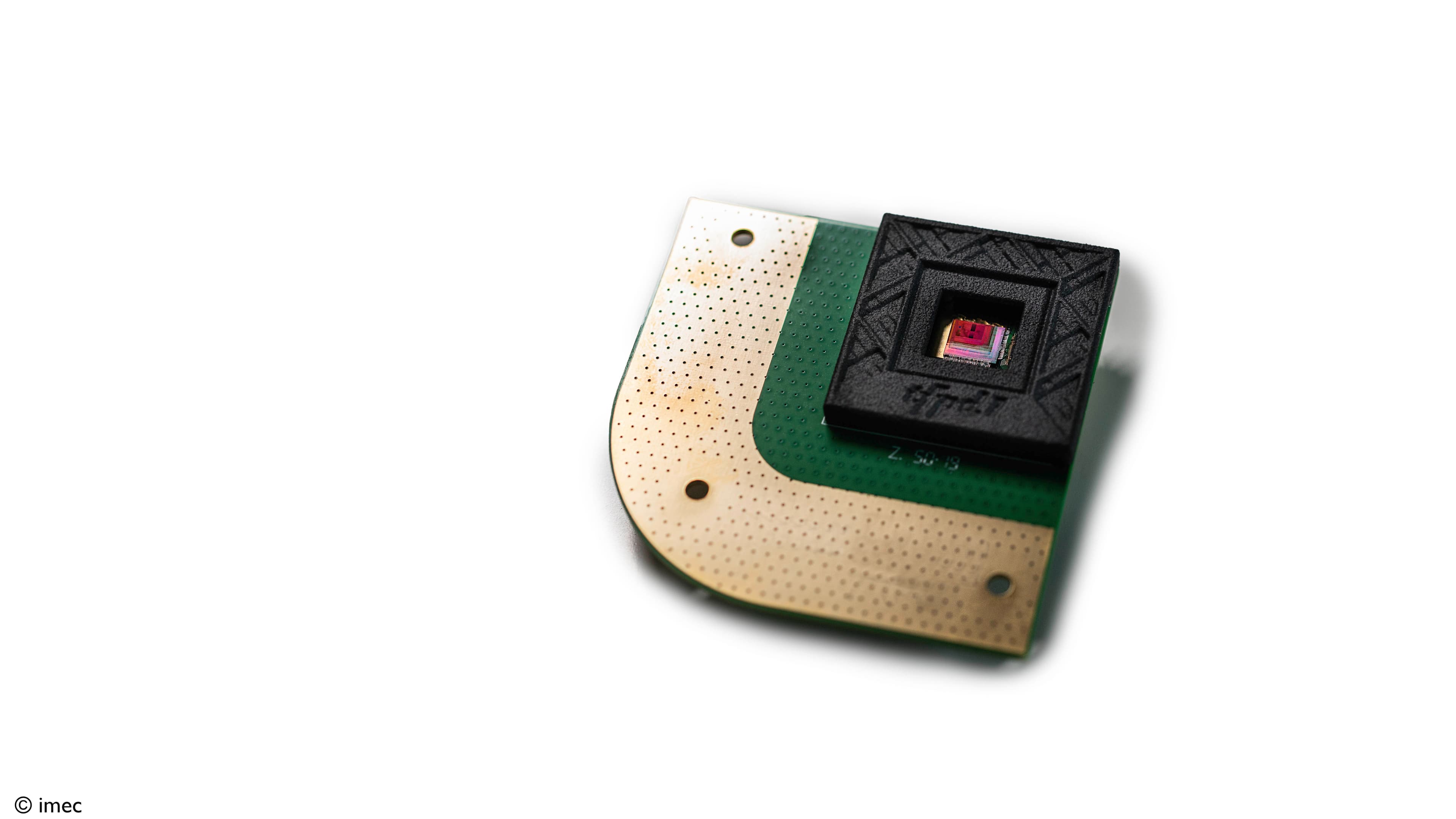 Lead-free-quantum-dot-photodiode-%28poc%29001_0 Quantum dot photodiode chip mounted on a green substrate with a square sensor window.