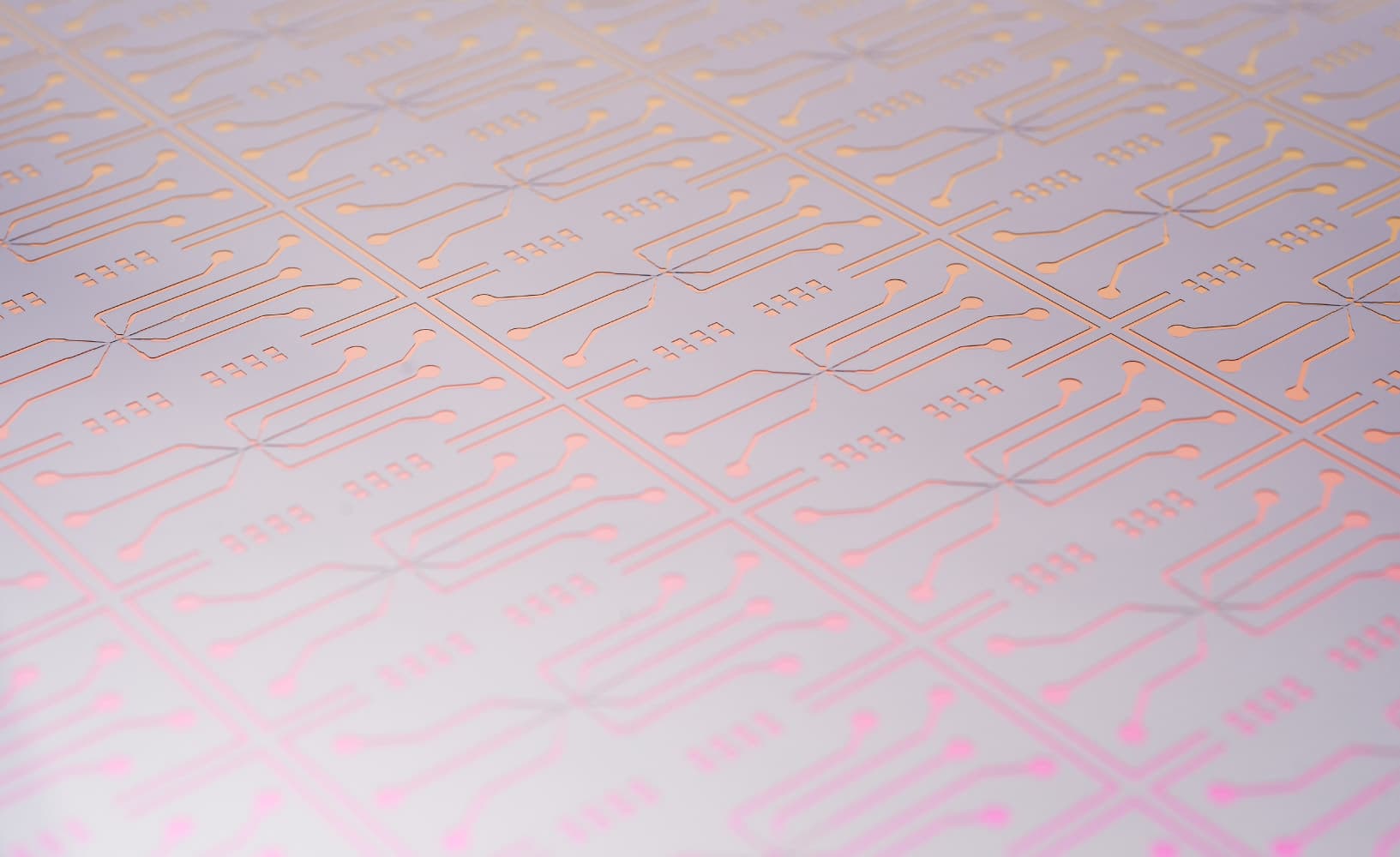 life-sciences-technology-platform-microfluidics_1 Close-up of a patterned silicon microchip with etched circuit traces in a grid