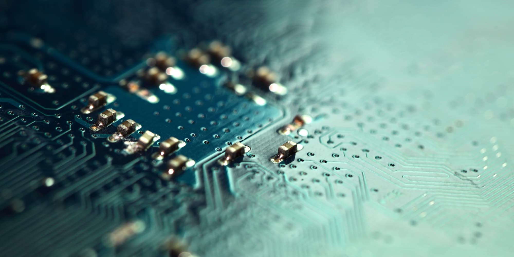 close-up of circuit board with components Close-up of a circuit board with tiny electronic components and blurred metallic reflections