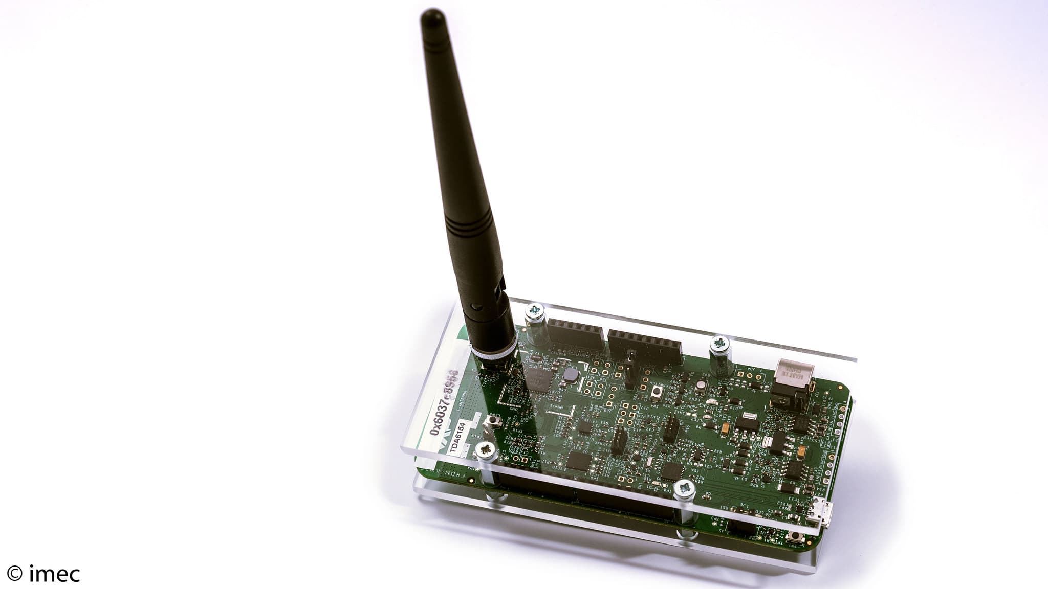 localization%20solution BLE circuit board prototype with an upright antenna in a clear acrylic case