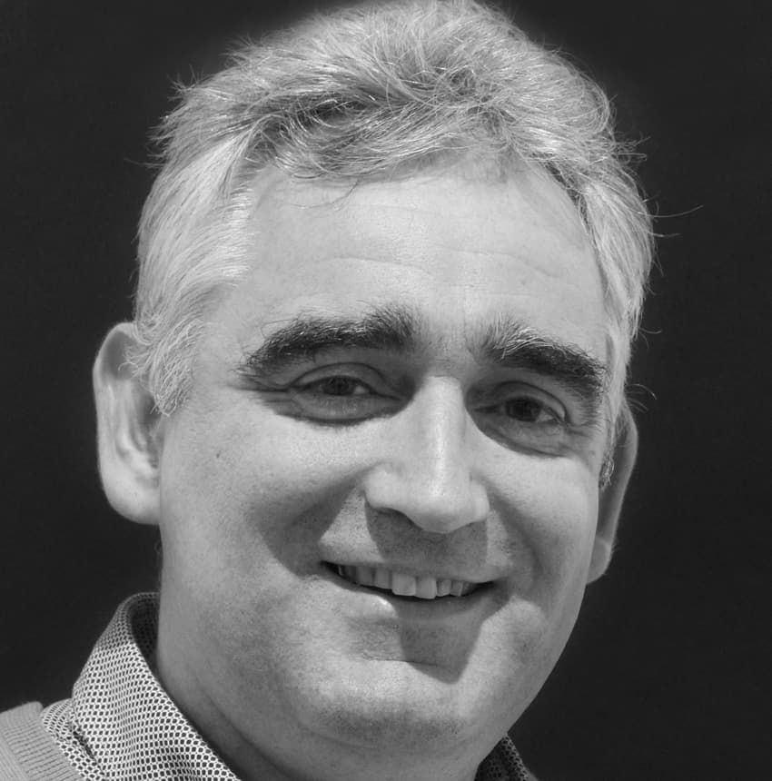 Luc Portrait of Luc Boschmans smiling against a dark background