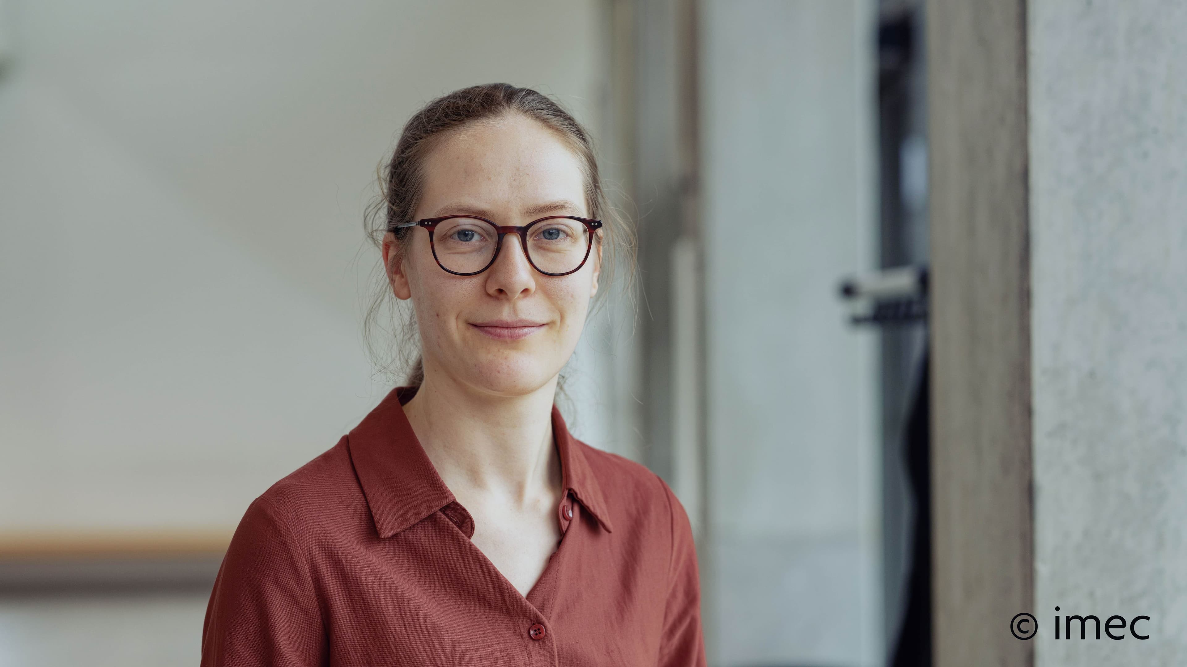 Margot%20Niels_2 Portrait of Margot Niels, PhD student in imec’s Photonics Research Group, wearing glasses and a rust-colored shirt.