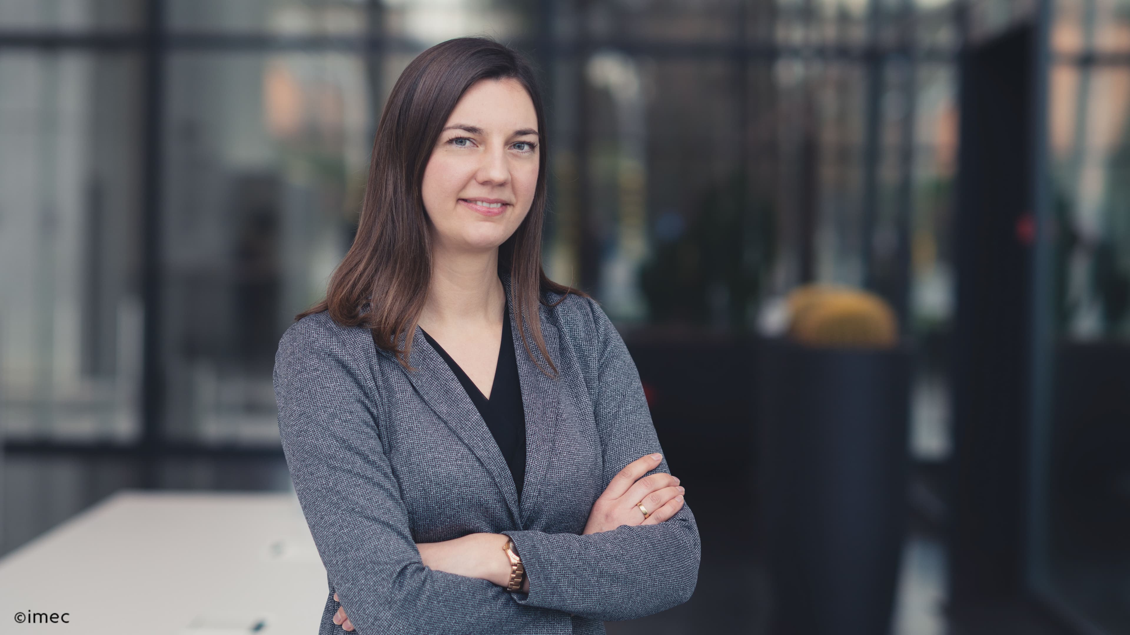 Marleen Portrait of Marleen Welkenhuysen standing with arms crossed in an indoor setting