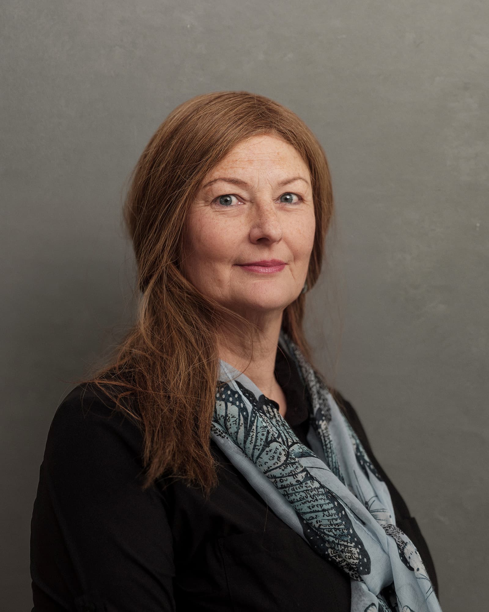 Melanie-Peters Portrait of Melanie Peters against a gray background