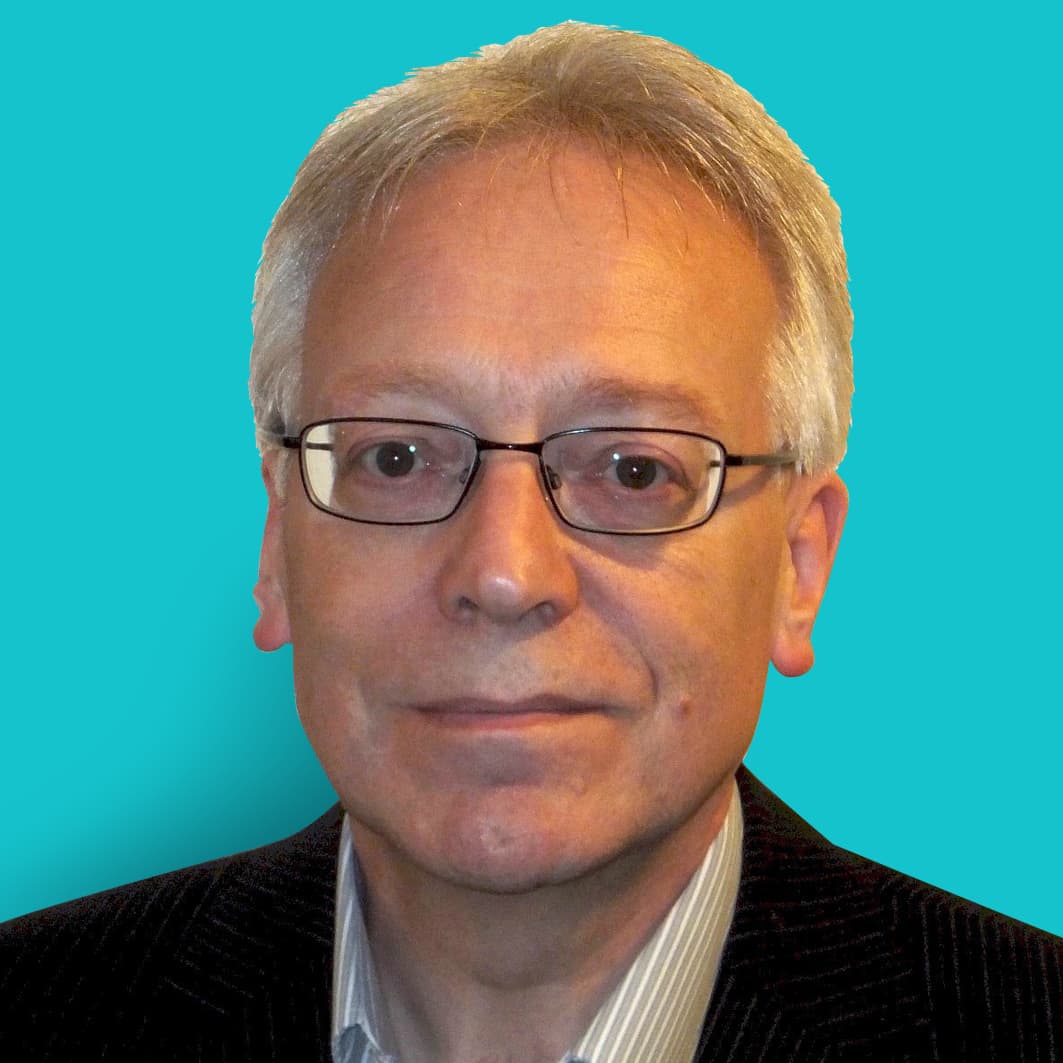 Mike-Davison-Picocom-PHOTO-SQ Portrait of Mike Davison against a teal background