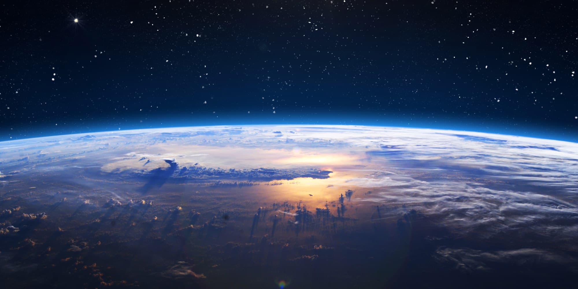 miniaturization-of-medical-devices-is-crucial-for-space-exploration Earth seen from space above a glowing horizon and starry sky