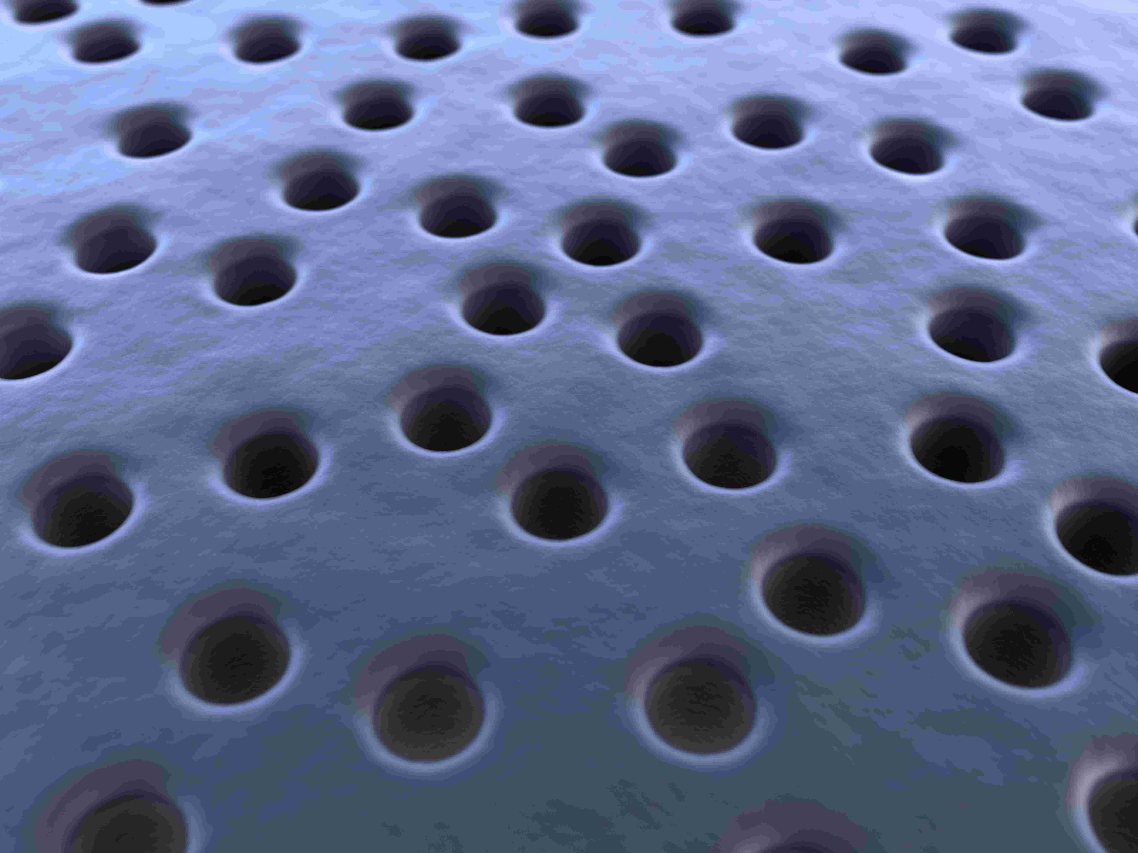 Nanopore%20proteomics%20sensing Close-up of a nanopore membrane with evenly spaced circular holes
