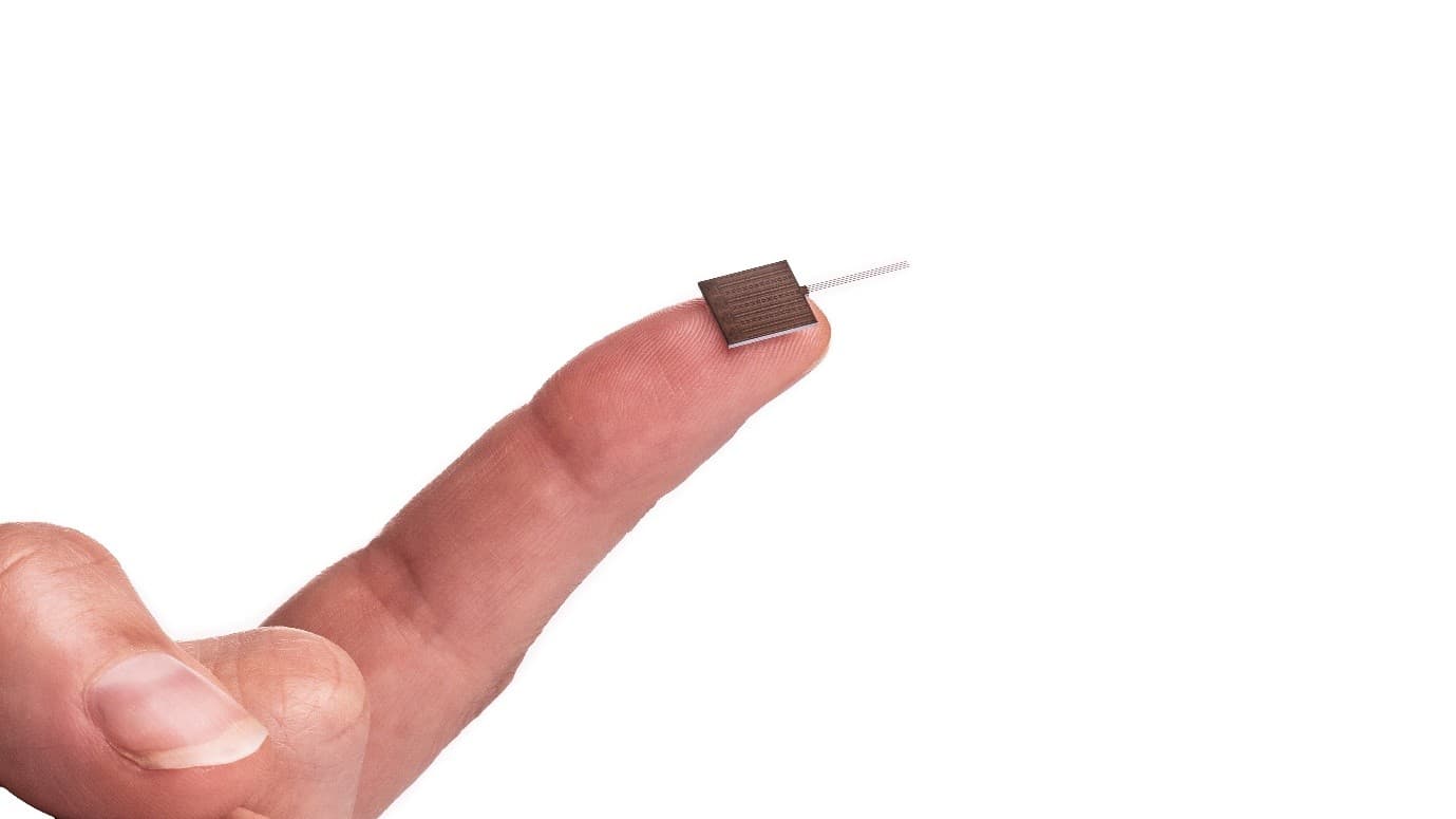 Neuroprobe_0 A fingertip holding a tiny neural probe chip with fine electrode traces