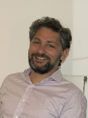 NikolasPapadopoulos Portrait of Nikolas Papadopoulos, smiling in a light striped shirt