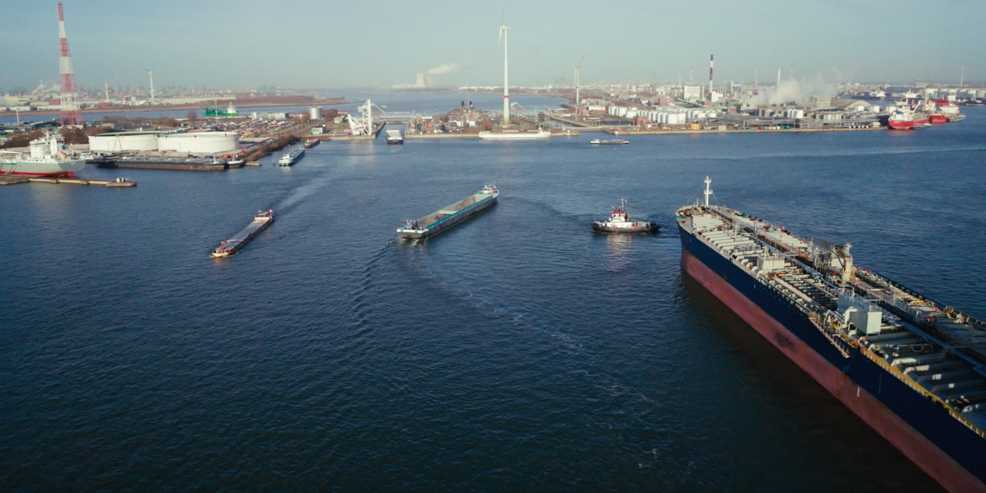 Nokia-and-Liberty-Global-partner-on-Network-as-a-Service-technology-to-develop-new-maritime-use-cases-at-Port-of-Antwerp_0 Aerial view of Antwerp harbor with cargo ships, tankers, and industrial port facilities