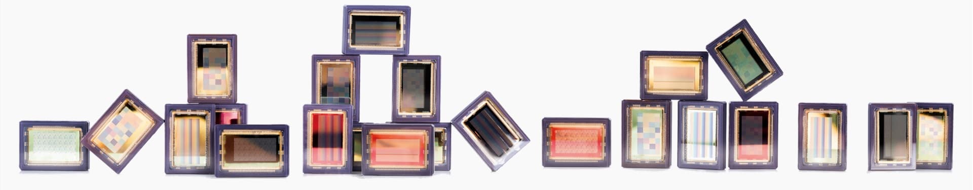 ots_hyperspectral_imaging_sensors_0 Row of hyperspectral imaging sensor chips in purple packages against a white background