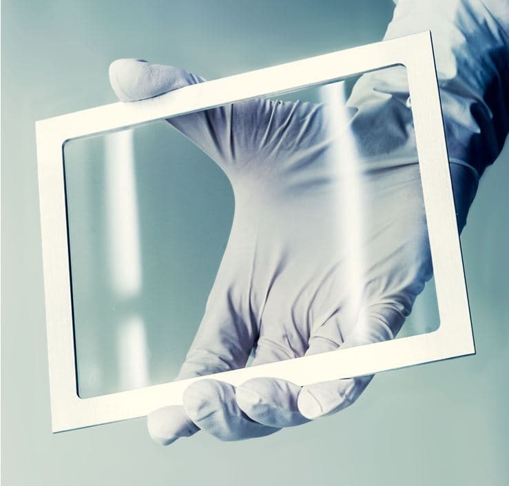 Pellicle_for_EUV_lithography_0 Gloved hand holding a rectangular frame for EUV lithography pellicle material