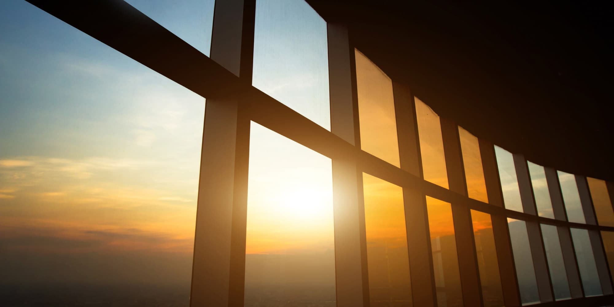 perovskiet_3 Sunlight glowing through tall glass panels at sunset