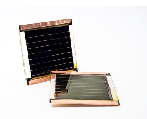 Perovskite_1 Two small photovoltaic cells with dark striped surfaces on a white background
