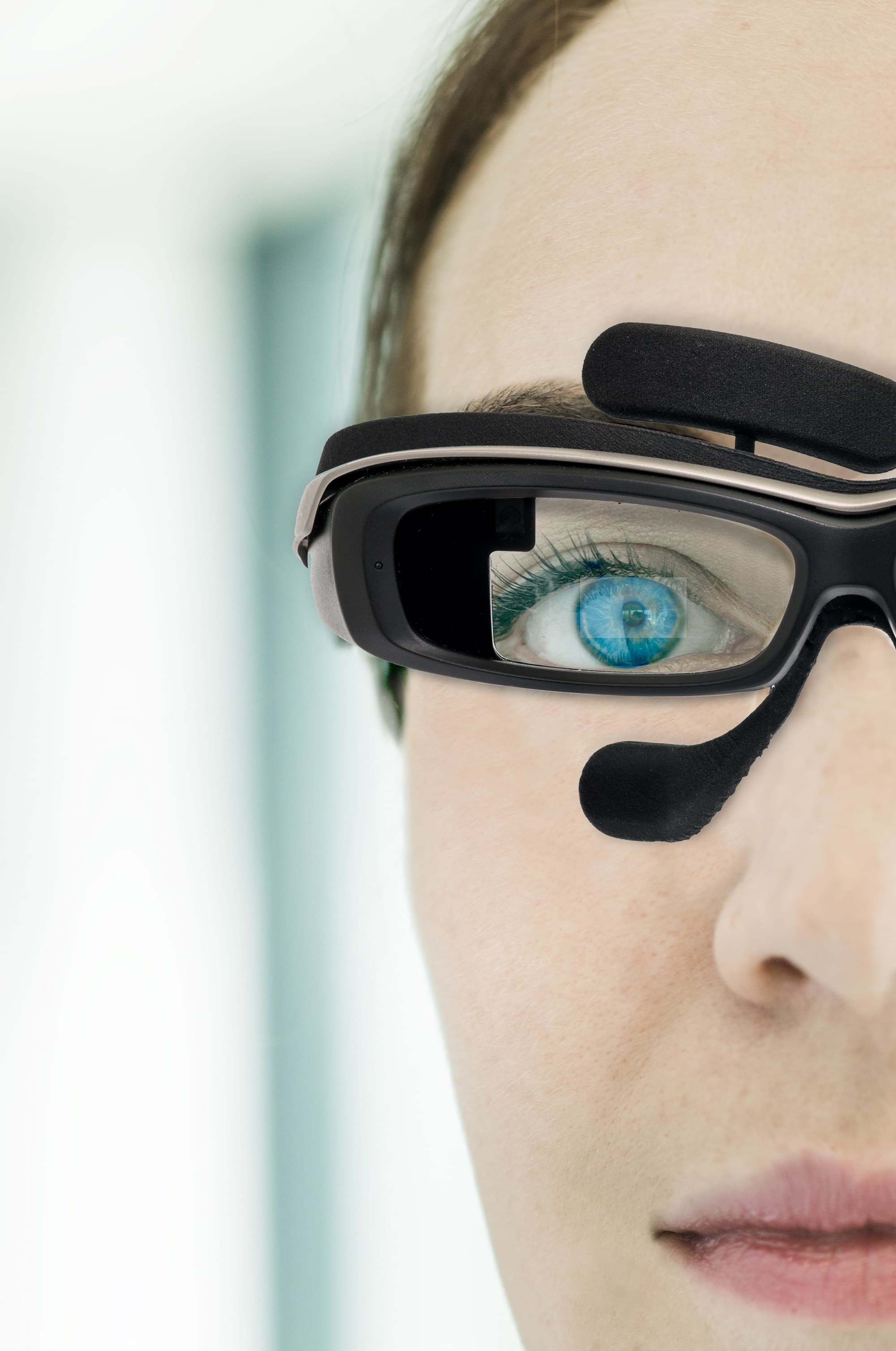 photo_eye_movement_PR_1 Close-up of a person wearing eye-tracking glasses with a camera over one eye.