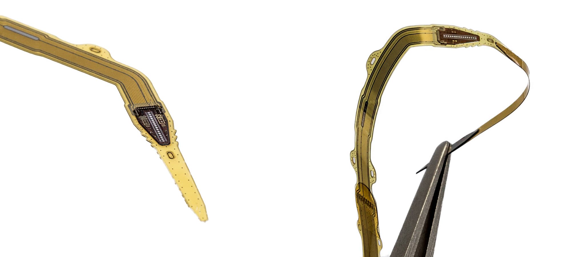 photo_IMPRESS_PR_1 Flexible implantable chip on a thin circuit strip, held by tweezers against a white background.