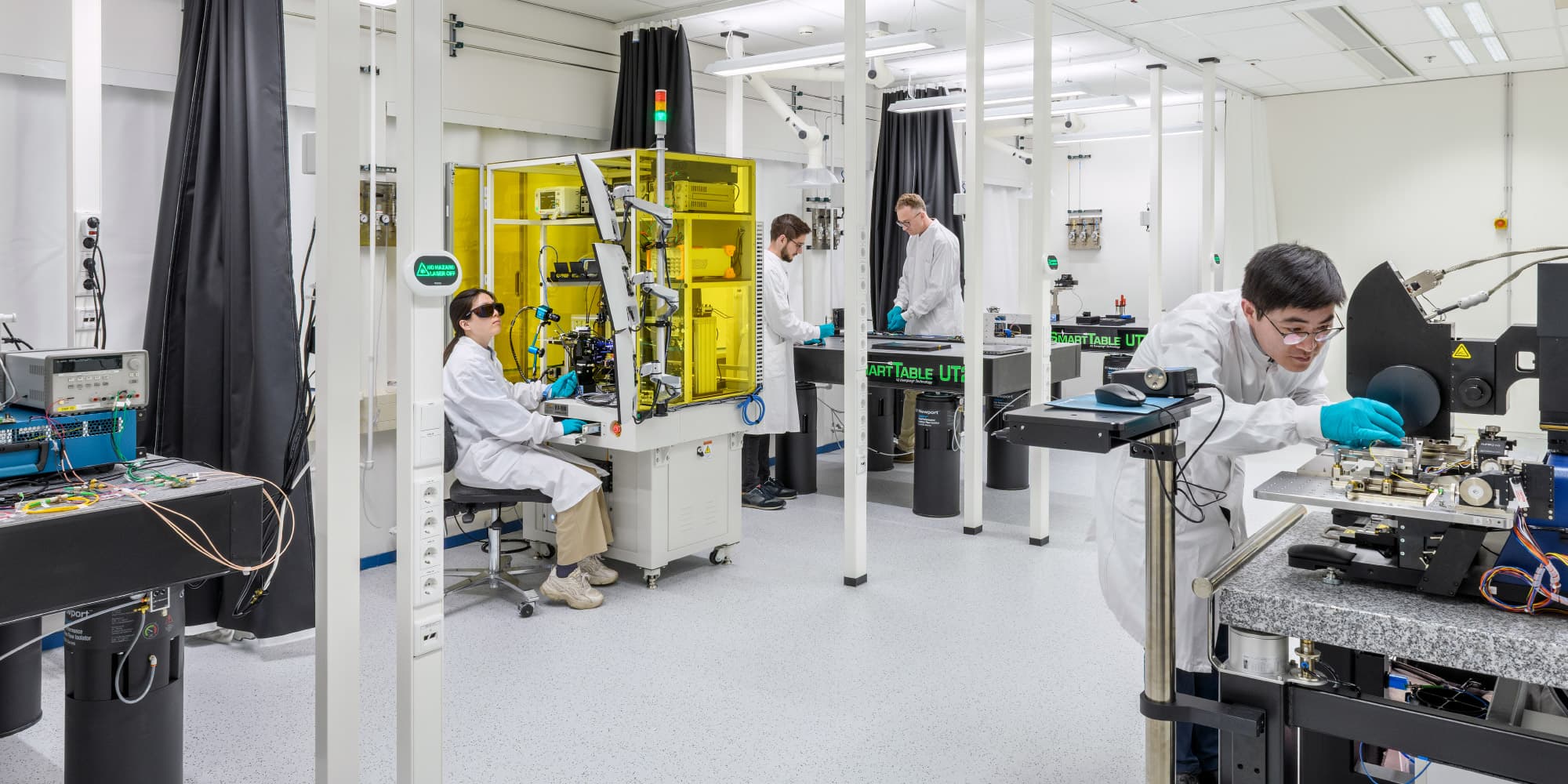 Photonics-lab-PR Researchers working with photonics equipment in a clean laboratory
