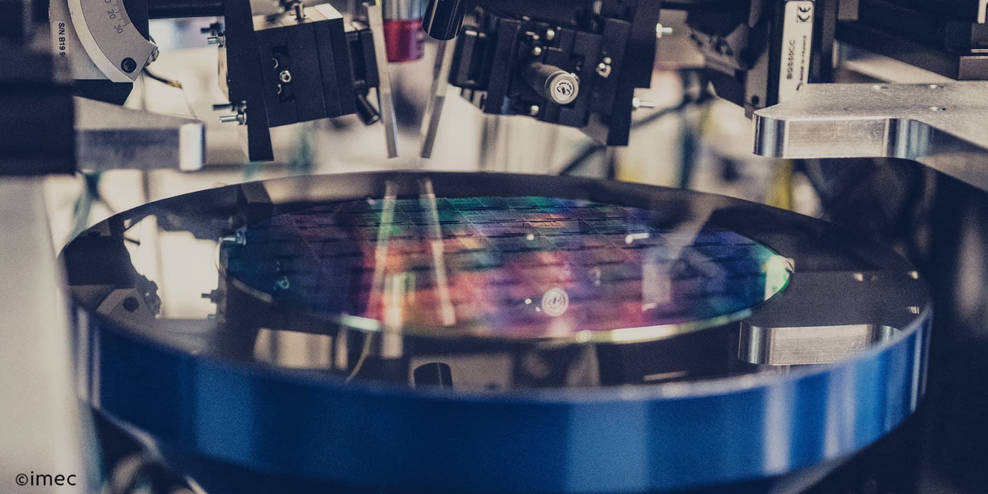 photonics Integrated photonics setup with a patterned semiconductor wafer under precision lab equipment