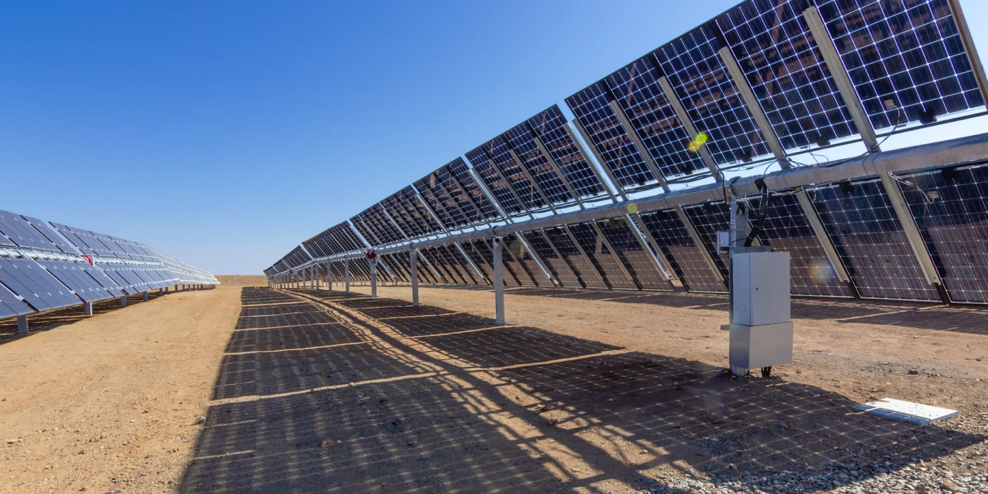 photovoltaics_header_0 Rows of bifacial solar panels in a desert test field under a clear blue sky