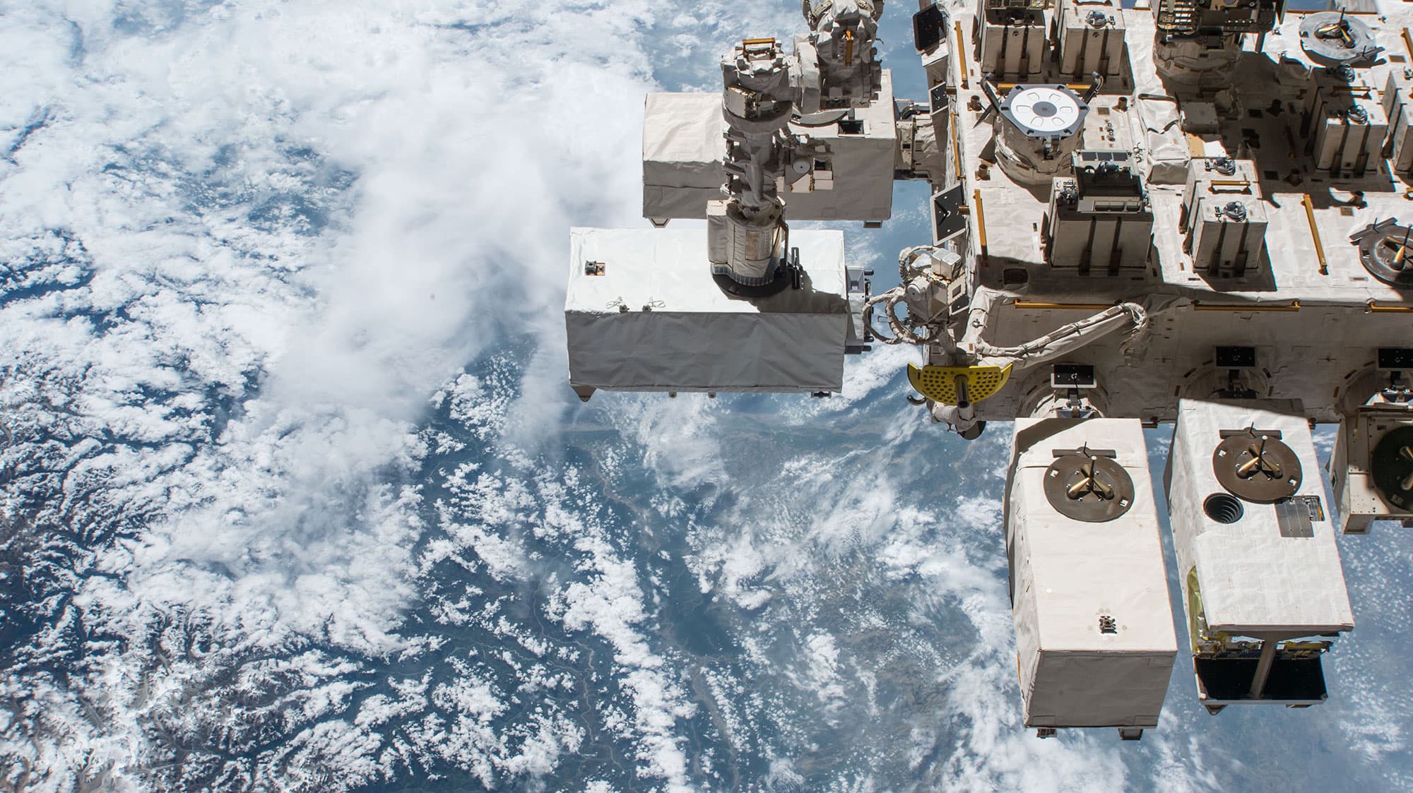 Picture_Nasa__ecostress20180706 Earth seen from space beside a satellite instrument platform and cloud cover
