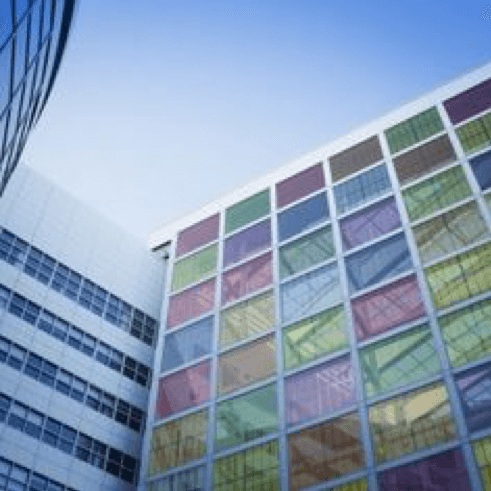 Building facade with colorful window panels Building facade with colorful window panels, suggesting perovskite solar cells integrated into glass